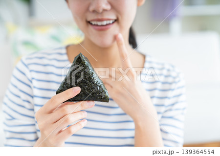 おにぎりを食べる若い女性 おにぎりを食べる若い女性 139364554