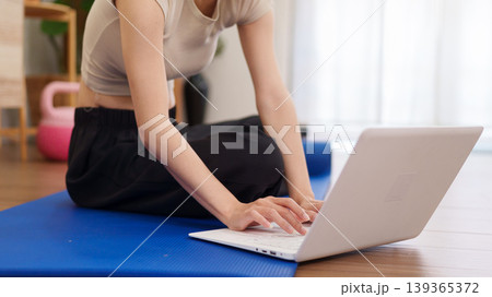 Asian women fitness instructor using laptop computer online training virtual class yoga workout exercise home gym workout mat wellness lifestyle healthy living Asian women fitness instructor using laptop computer online training virtual class yoga workout exercise home gym workout mat wellness lifestyle healthy living 139365372