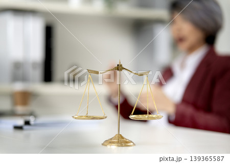 Asian adult professional woman legal office justice balance scale concept fairness equity principles 139365587