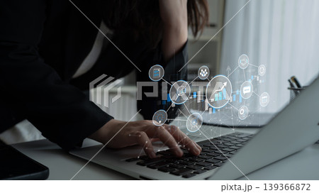 A business professional focuses on data trends displayed on a laptop, with digital graphs and statistics representing technology and analytical innovation in a corporate setting. Sigmoid A business professional focuses on data trends displayed on a laptop, with digital graphs and statistics representing technology and analytical innovation in a corporate setting. Sigmoid 139366872