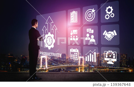 Businessman Looking at Digital Productivity Icon Set with Graphs, Charts, and Symbols Against a City Skyline Background at Night Ledger Businessman Looking at Digital Productivity Icon Set with Graphs, Charts, and Symbols Against a City Skyline Background at Night Ledger 139367648
