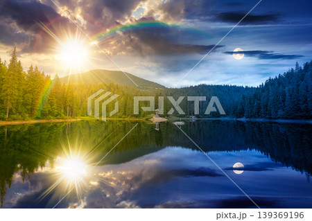 day meet night. landscape by the lake. coniferous forest near the lake and the forest mountain. epic summer solstice view of carpathian mountain reflection on synevr lake surface. harmony concept 139369196