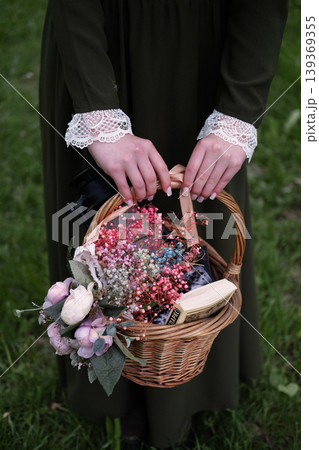 Girl holding a wicker basket. Girl holding a wicker basket. 139369355