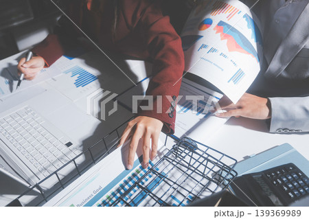 business people or accountant using calculator while working analytical business report on the workplace, accounting concept, Serious and focused financier accountant on paper work inside office, business people or accountant using calculator while working analytical business report on the workplace, accounting concept, Serious and focused financier accountant on paper work inside office, 139369989