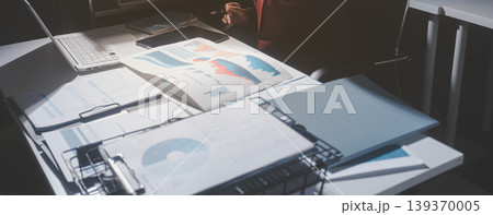 business people or accountant using calculator while working analytical business report on the workplace, accounting concept, Serious and focused financier accountant on paper work inside office, business people or accountant using calculator while working analytical business report on the workplace, accounting concept, Serious and focused financier accountant on paper work inside office, 139370005