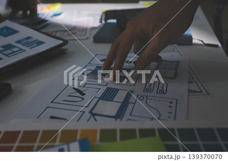 Team of Program Developer Collaborating on UXUI Design Planning in a Modern Office Environment 139370070