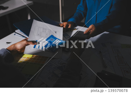 Team of Program Developer Collaborating on UXUI Design Planning in a Modern Office Environment 139370078