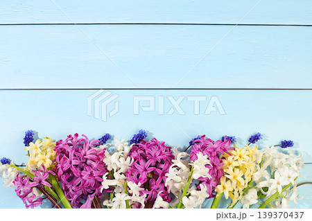 Abstract floral arrangement of spring flowers for web design and templates. A beautiful flyer with white, burgundy, and purple hyacinths and blue muscari on an elegant, vibrant background. Abstract floral arrangement of spring flowers for web design and templates. A beautiful flyer with white, burgundy, and purple hyacinths and blue muscari on an elegant, vibrant background. 139370437