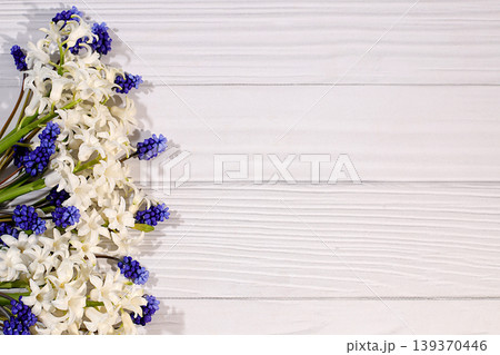 Abstract floral arrangement of spring flowers for a web design and template. A beautiful flyer with white hyacinths and blue muscari on an elegant, vibrant background. 139370446