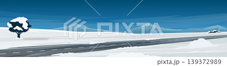 Horizontal or Landscape view of asphalt road that passes through a snow covered plain. Tree standing alone on a snow covered hill. Background of mountain under night sky. 139372989
