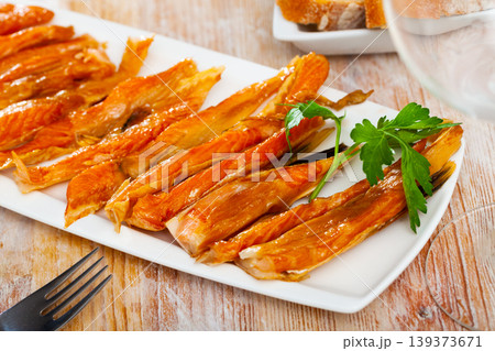 Image of slices of smoked salmon belly at plate Image of slices of smoked salmon belly at plate 139373671