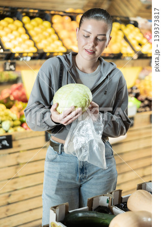Woman buyer choosing fresh cabbage at vegetable market Woman buyer choosing fresh cabbage at vegetable market 139373817