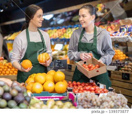 Owners of the grocery store hold ripe fruit in their hands 139373877