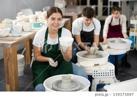 Young woman holding crafted clay cup Young woman holding crafted clay cup 139373897