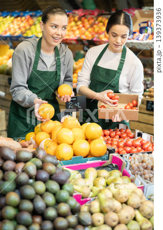 Owners of the grocery store hold ripe fruit in their hands 139373936