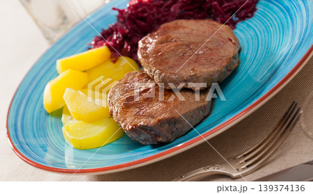 Veal steaks with potato and marinated cabbage Veal steaks with potato and marinated cabbage 139374136
