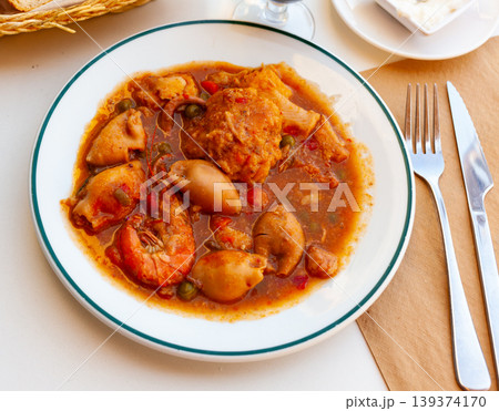 Close up of traditional spanish zarzuela on white plate on white tablecloth Close up of traditional spanish zarzuela on white plate on white tablecloth 139374170