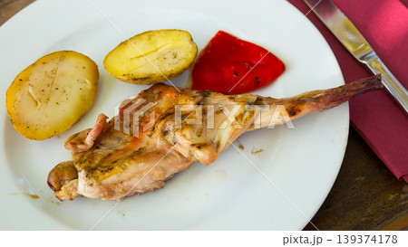 Grilled rabbit piece with vegetable garnish Grilled rabbit piece with vegetable garnish 139374178