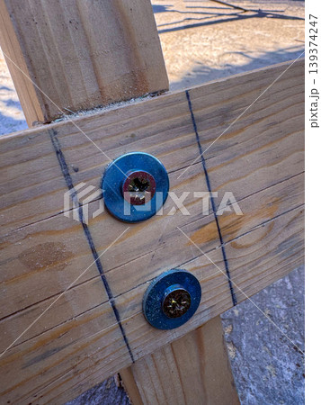 Wood and metal connection is prepared at a construction site in the afternoon Wood and metal connection is prepared at a construction site in the afternoon 139374247