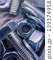 Different types of nuts and bolts arranged in a pile for hardware use 139374958