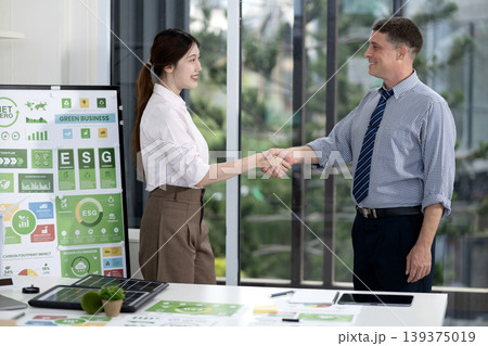 Business Professionals Shaking Hands Green Business ESG Sustainability Strategy Office Meeting Collaboration 139375019
