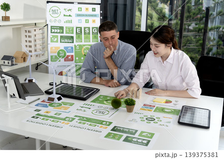 caucasian businessman and asian businesswoman discussing ESG strategy caucasian businessman and asian businesswoman discussing ESG strategy 139375381