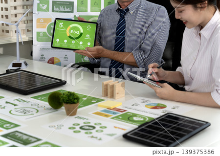 caucasian businessman and asian businesswoman discussing ESG strategy caucasian businessman and asian businesswoman discussing ESG strategy 139375386