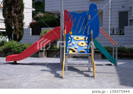 公園の赤と青の小さな滑り台とボルダリング遊具 子供向け複合遊具 屋外 139375944