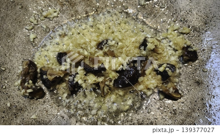 Cooking Sliced Shiitake Mushrooms and Minced Garlic in a Hot Sizzling Pan 139377027