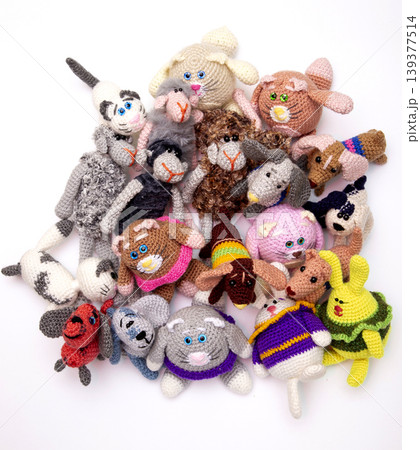 Various knitted woolen toys on a white background 139377514
