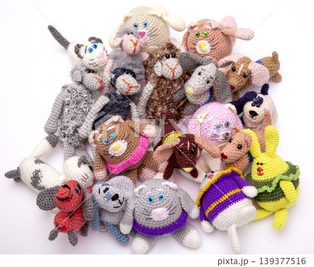 Various knitted woolen toys on a white background 139377516