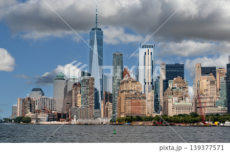 New york, usa august 16,2024. Lower manhattan skyline across the water with one world trade center and iconic skyscrapers under a bright blue sky New york, usa august 16,2024. Lower manhattan skyline across the water with one world trade center and iconic skyscrapers under a bright blue sky 139377571