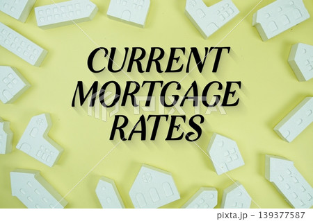 Current Mortgage Rates text with house models on yellow background Current Mortgage Rates text with house models on yellow background 139377587