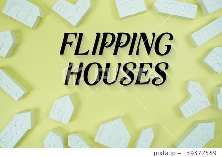 Flipping Houses text with house models on yellow background Flipping Houses text with house models on yellow background 139377589