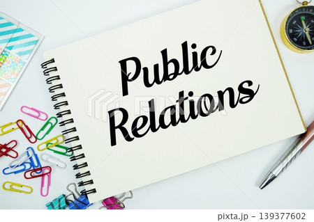 Public Relations text message written on notepad with stationery flat lay on white background Public Relations text message written on notepad with stationery flat lay on white background 139377602