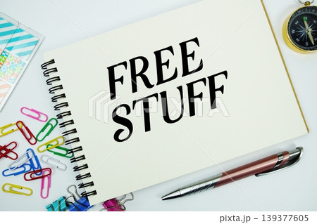 Free Stuff text message written on notepad with stationery flat lay on white background 139377605