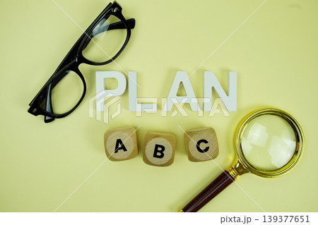 Plan A, Plan B, Plan C with eye glasses and magnifying glass on yellow background 139377651