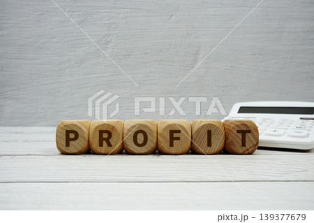 PROFIT alphabet letters with calculator on wooden background PROFIT alphabet letters with calculator on wooden background 139377679