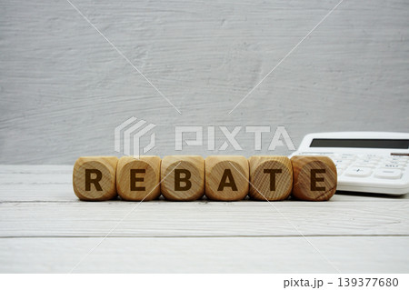 REBATE alphabet letters with calculator on wooden background REBATE alphabet letters with calculator on wooden background 139377680