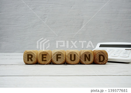REFUND alphabet letters with calculator on wooden background REFUND alphabet letters with calculator on wooden background 139377681