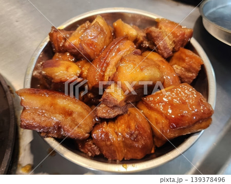 Delicious Braised Pork Belly Chunks with Glossy Soy Glaze in a Bowl 139378496