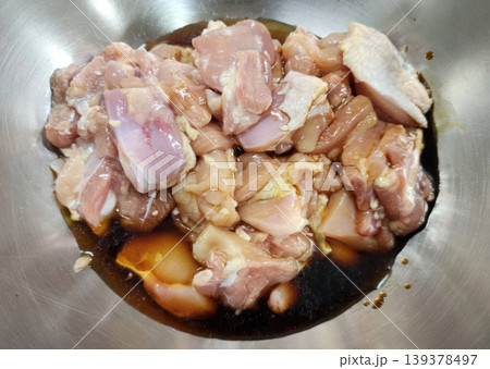 Raw Marinated Chicken Pieces in Soy Sauce Inside a Stainless Steel Bowl Raw Marinated Chicken Pieces in Soy Sauce Inside a Stainless Steel Bowl 139378497