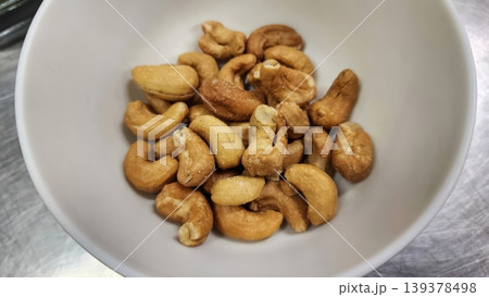 Roasted Salted Cashew Nuts in a White Ceramic Bowl - Healthy Snack Food 139378498