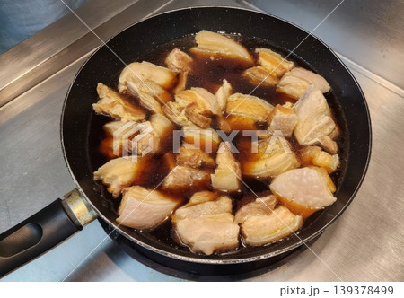 Slow Cooking Braised Pork Belly Chunks in Savory Soy Sauce Marinade in a Pan Slow Cooking Braised Pork Belly Chunks in Savory Soy Sauce Marinade in a Pan 139378499