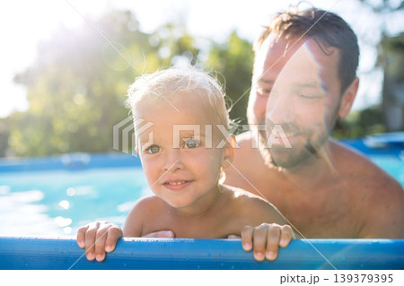 Father trying to teach little boy to swim. Father trying to teach little boy to swim. 139379395