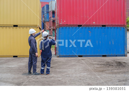 Mid-adult Caucasian Male and Black Female Logistics Workers Coordinating Cargo at Terminal Mid-adult Caucasian Male and Black Female Logistics Workers Coordinating Cargo at Terminal 139381031