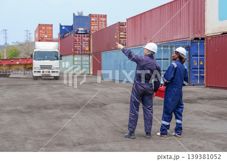 Mid-adult Caucasian Male and Black Female Logistics Workers Coordinating Cargo at Terminal Mid-adult Caucasian Male and Black Female Logistics Workers Coordinating Cargo at Terminal 139381052
