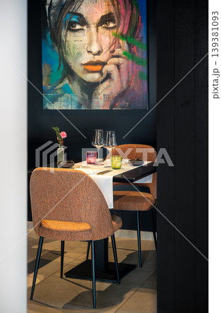 Romantic table with soft ambiance. Elegant dinner scene featuring artwork and dim lighting ambiance Romantic table with soft ambiance. Elegant dinner scene featuring artwork and dim lighting ambiance 139381093