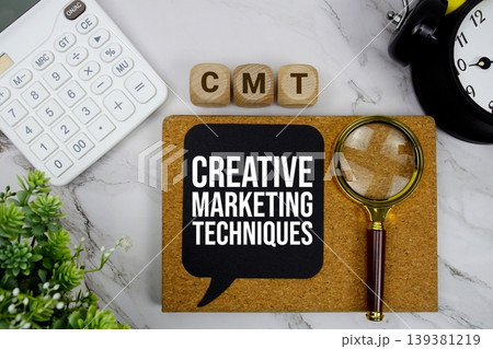 CMT Creative Marketing Techniques text with calculator, magnifying glass and alarm clock on marble background 139381219
