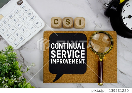 CSI Continual Service Improvement text with calculator, magnifying glass and alarm clock on marble background 139381220